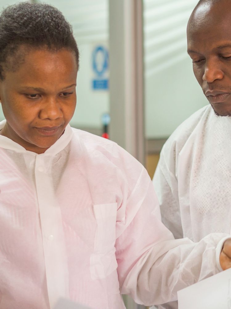 Colleagues reviewing a document in the laboratory