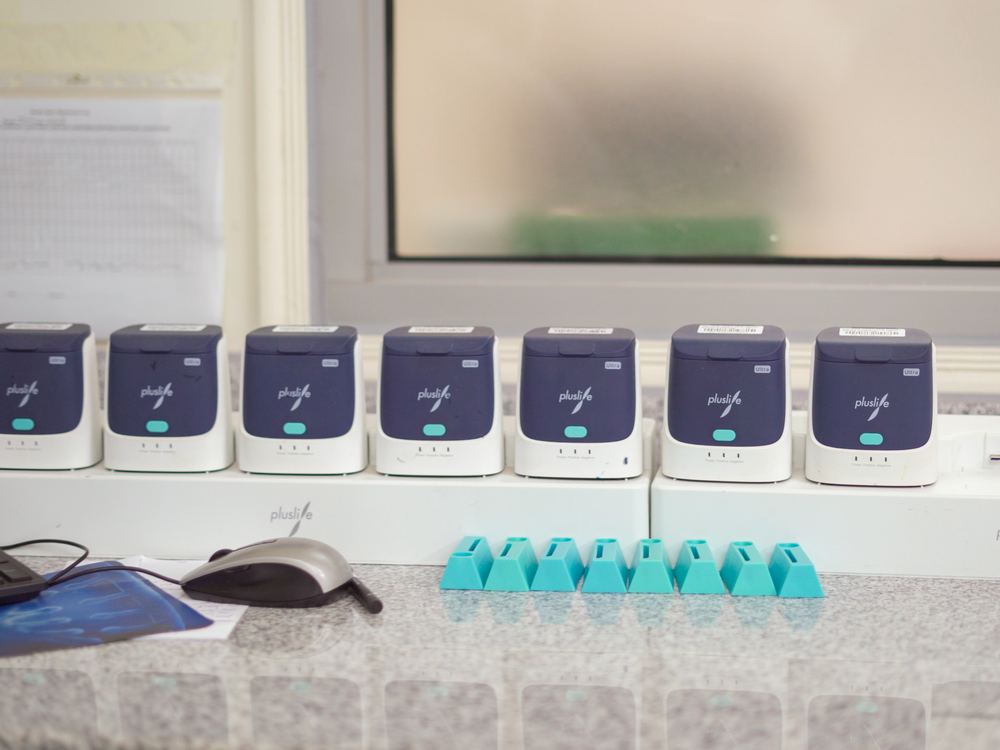 Row of compact laboratory instruments on a bench