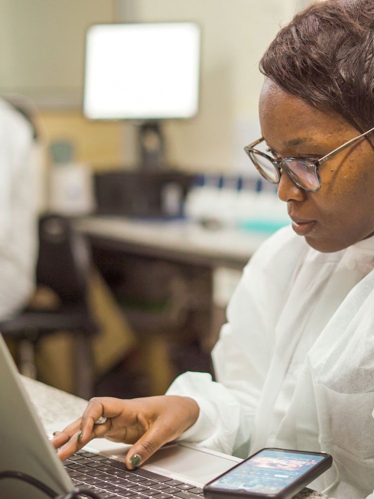 Scientist entering results on a laptop